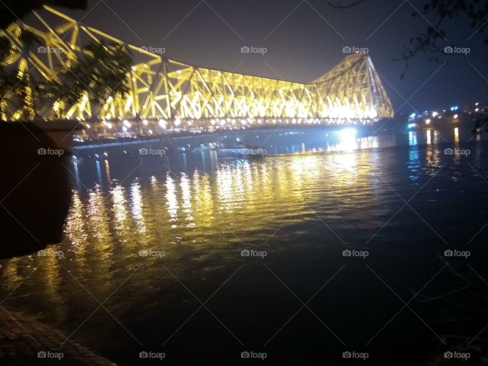 Night Scene of Illuminated Howrah bridge Over Hugli River, Kolkata City India.  Constructed in 1942 AD,
Quality-Pillar less
Made from Steel