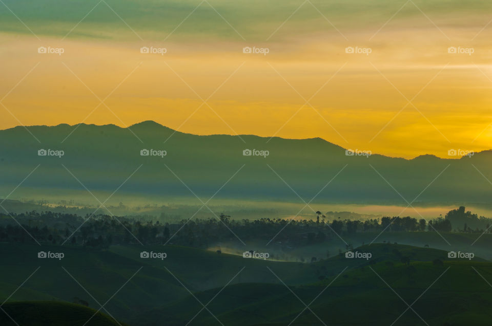 Silhouetted mountain range during sunrise