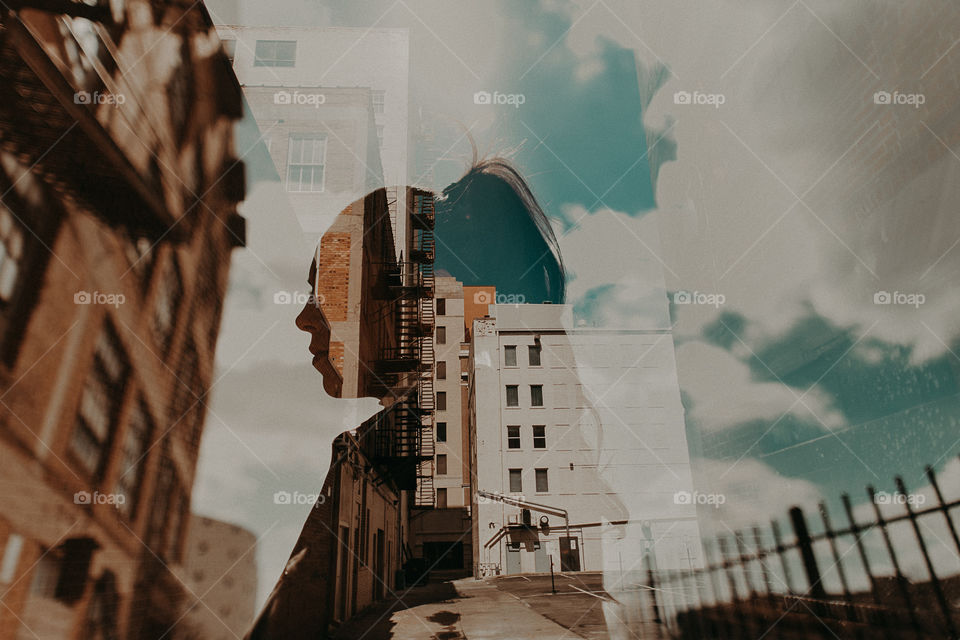 Double exposure against colorful cityscape