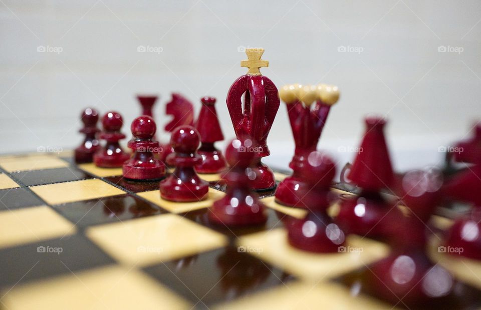 chess board with red and beige chess