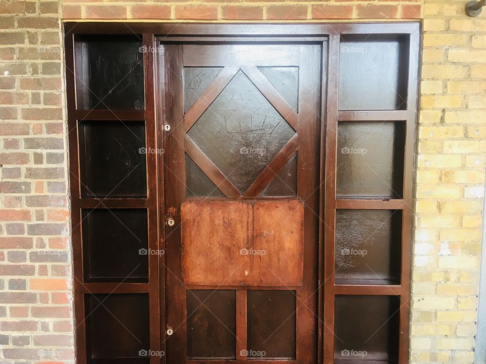 Triple locked wooden door between shops in Bennetts End, Hemel Hempstead, Hertfordshire. Passed in Spring.