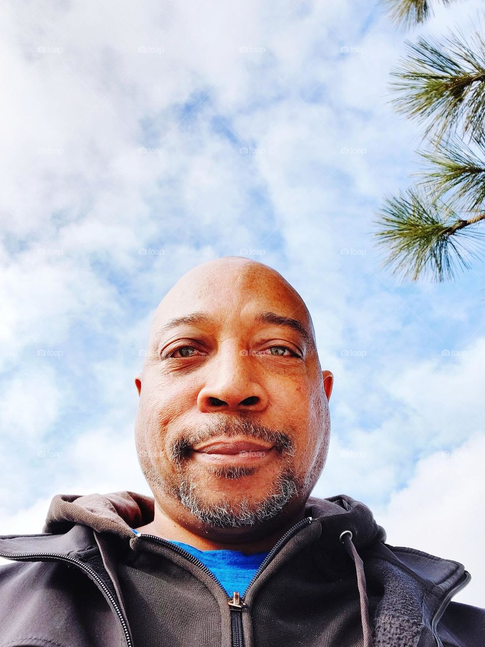 selfie with white clouds in the background