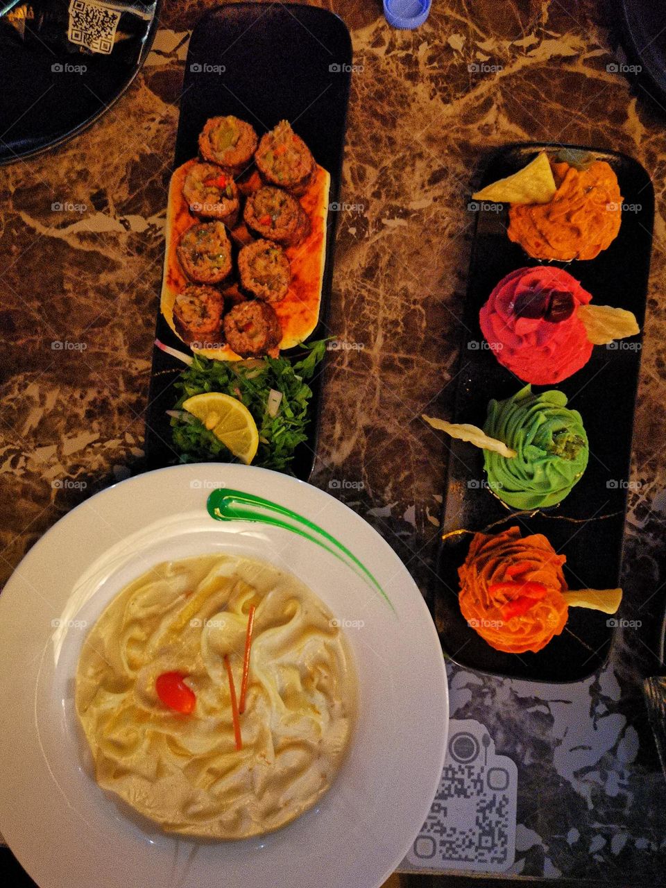 Fuccine pasta with meat kebab and assorted salads Business dinner