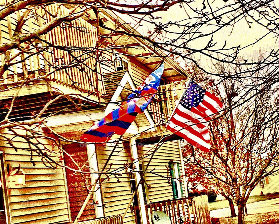 The World Series Champions Cubs flag proudly flies in the strong wind, alongside the United States of America flag, at Apartment C!