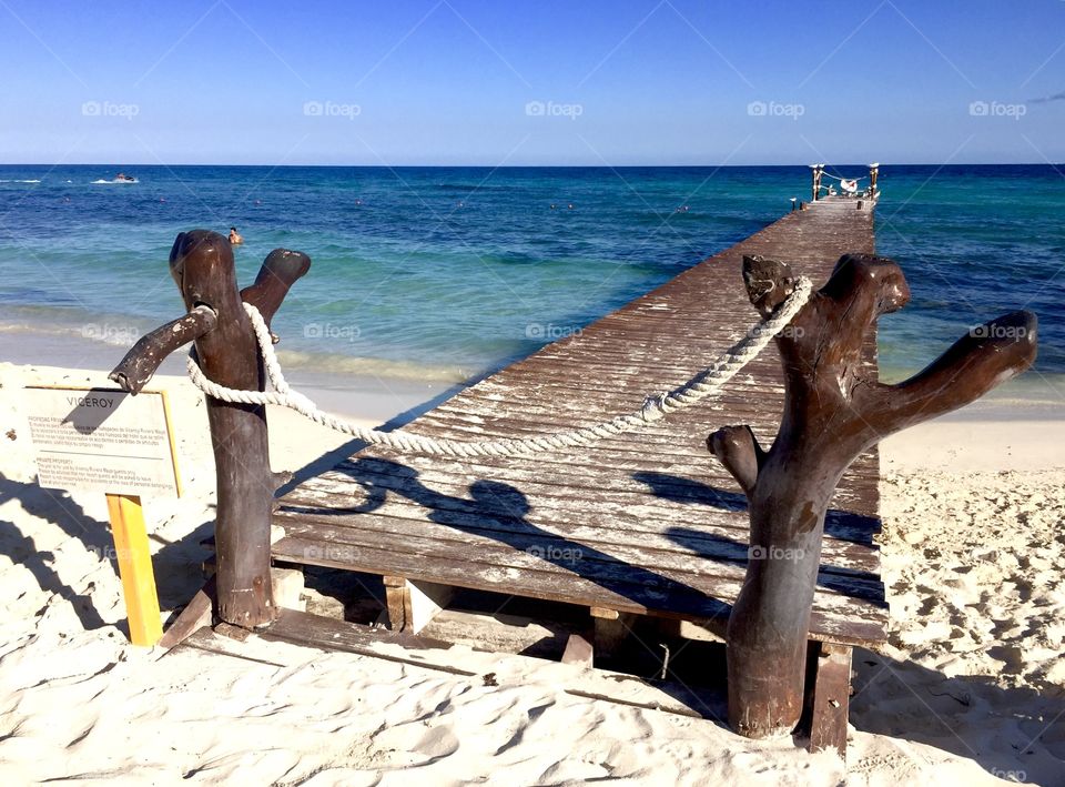 Wooden pier on the white beach of Mexico