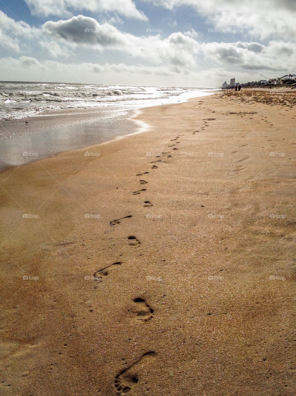 Footsteps on the beach by the sea