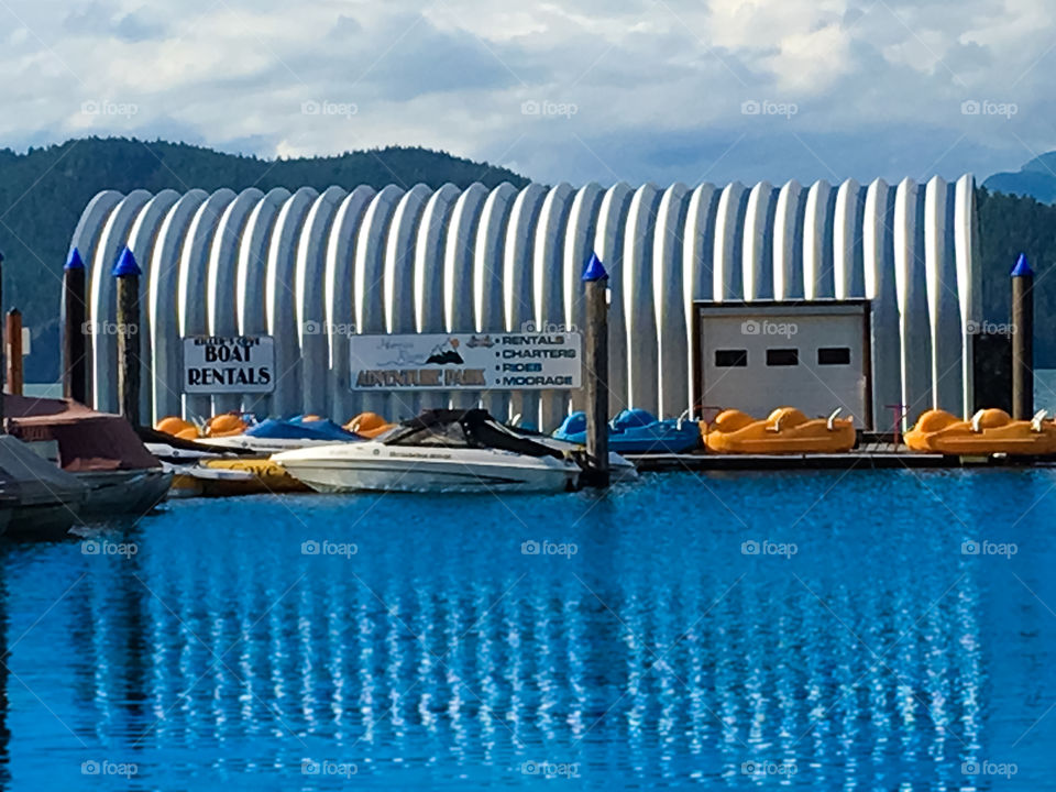 Corrugated steel boathouse reflection on the lake