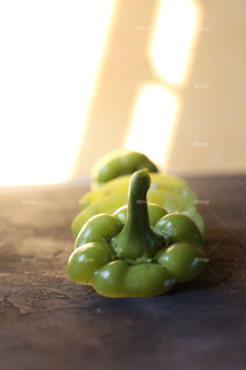 Green pepper on the black background 
