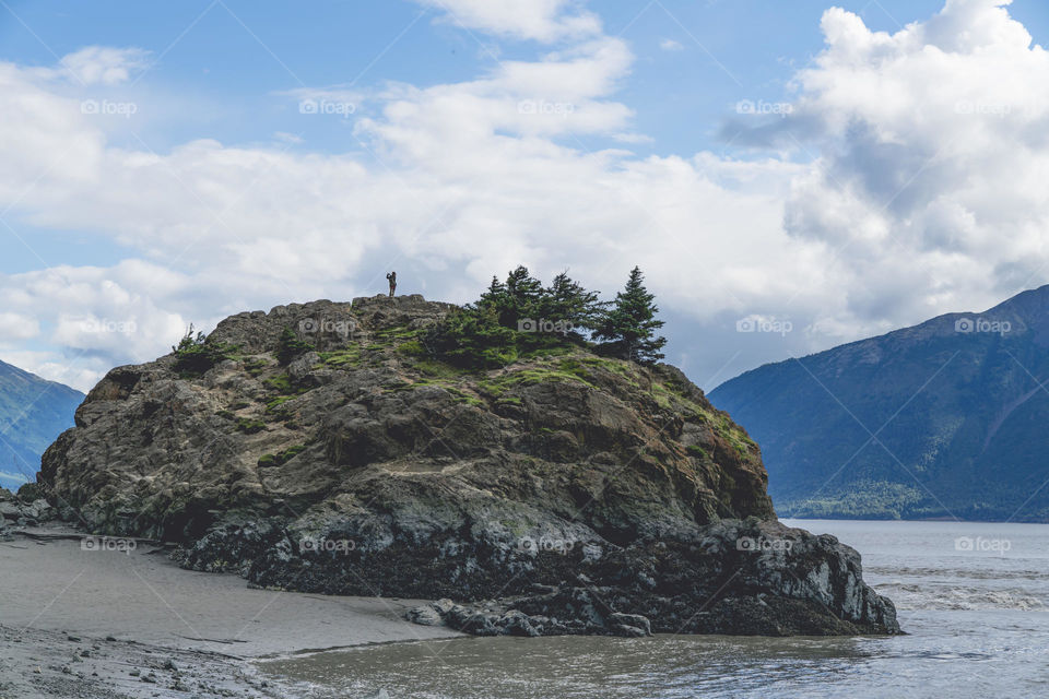 Person enjoys s mountain scene in Alaska. 