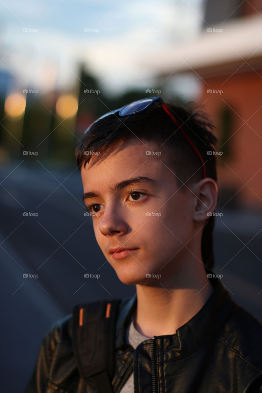 Portrait of teenage boy in the sunset light.