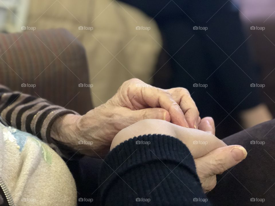 A Grandmother and Her Granddaughter Holding Hands.