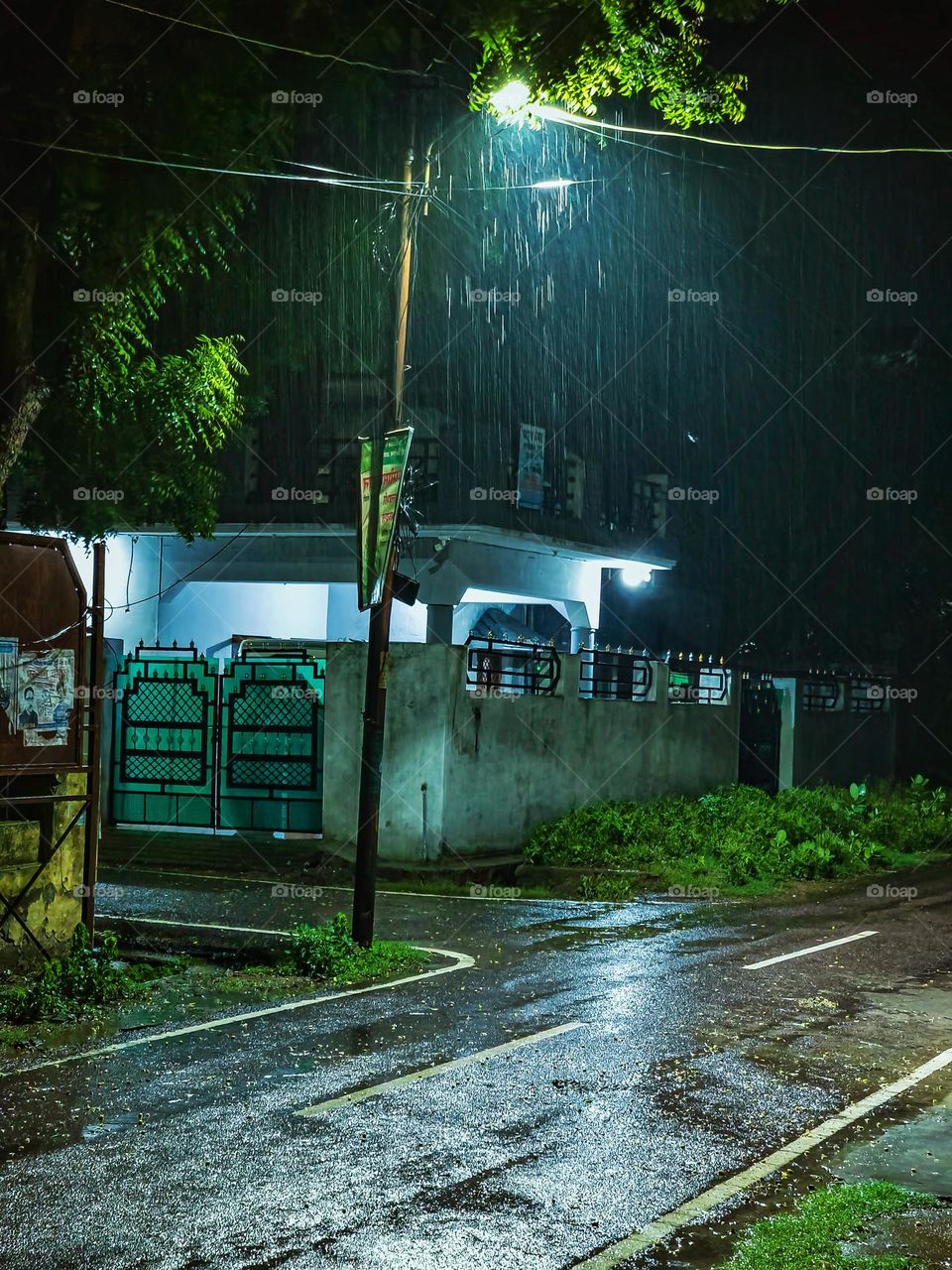 Rain drops falling at night under the street light