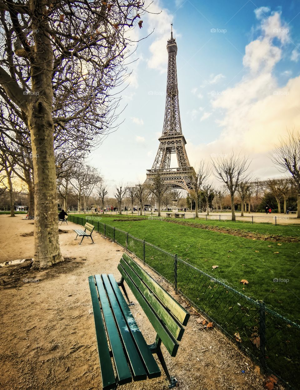 Bench with park and Eiffel Tower view behind 