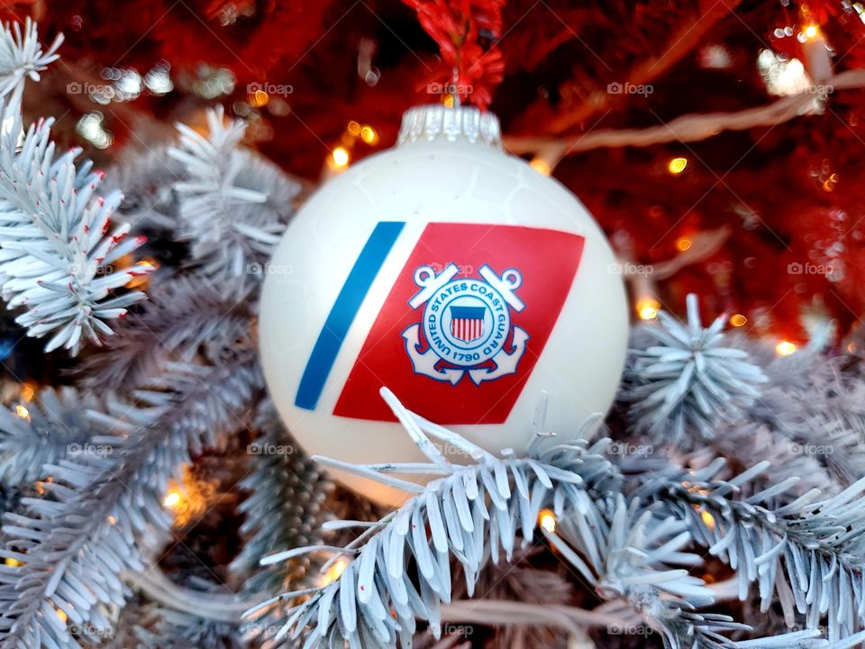 United States Coast Guard Christmas ornament hanging on a red, white and blue Christmas tree honoring all branches of service