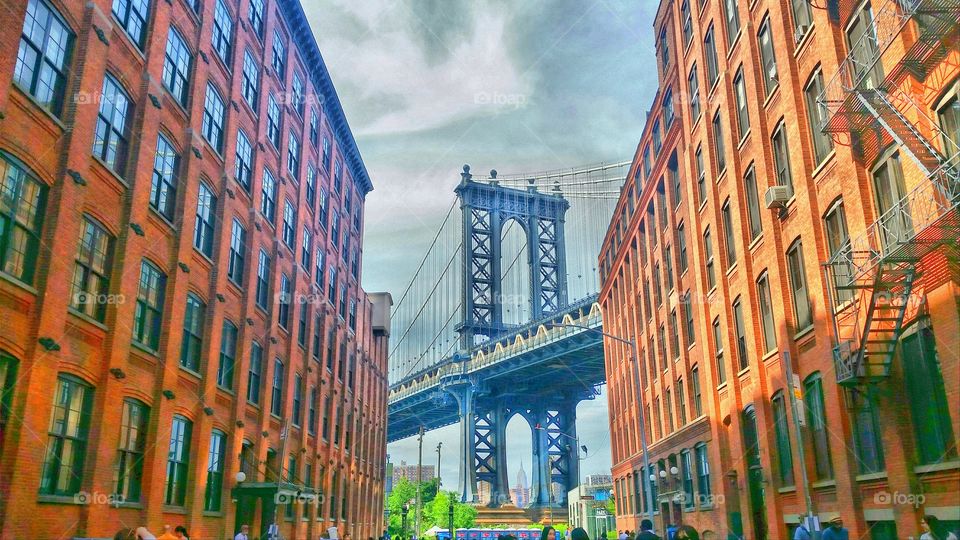 Empire State building through an arch of the Manhattan bridge in New York
