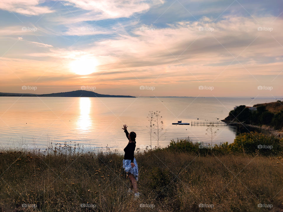 Welcoming the sunset on the seashore