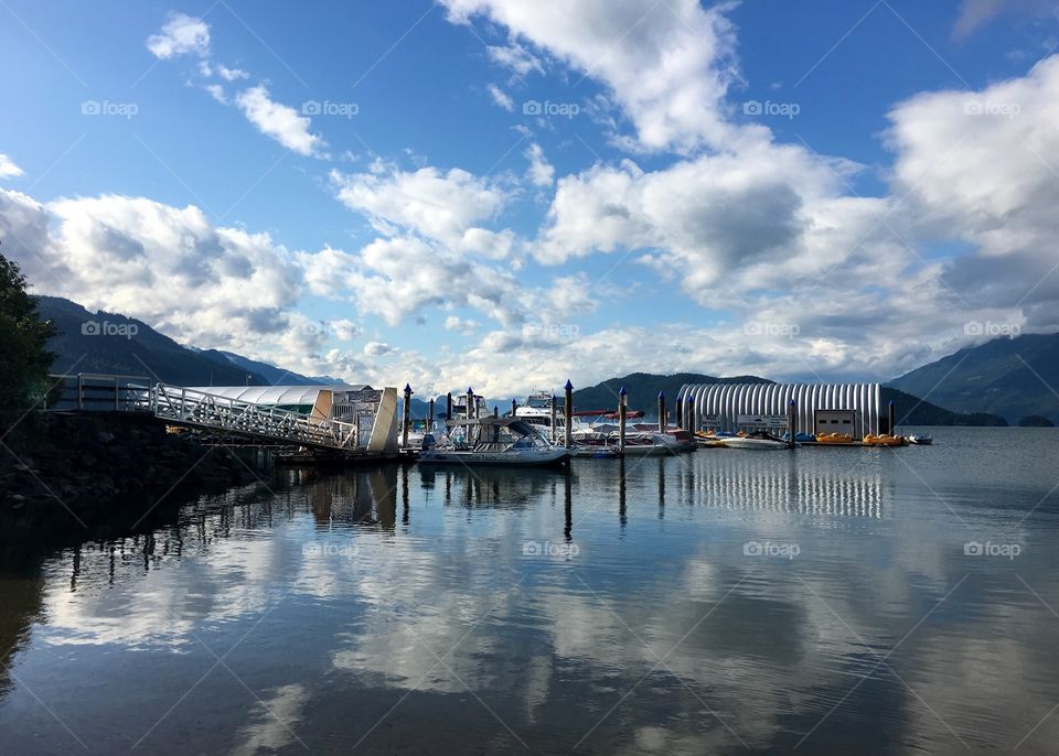 View of Harrison Lake in beautiful British Columbia Canada, the Marina at Harrison Hotsprings; calm water, reflections, surrounded by mountains