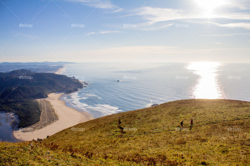 Cascade head hike overlooking grassy fields and the Pacific Ocean 