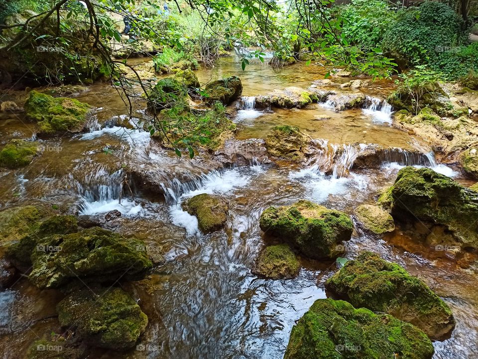 fast stream with rocks and moss