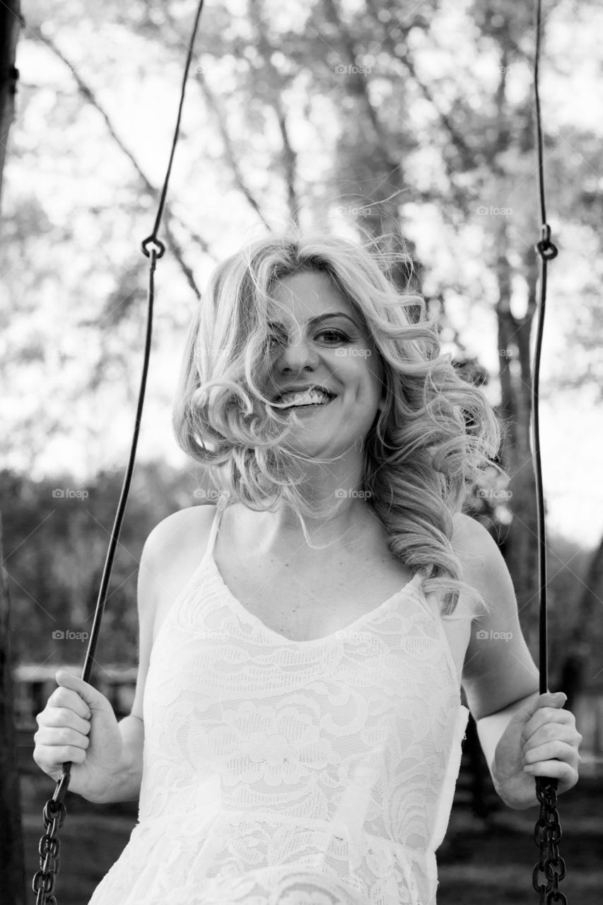 happy woman on a swing. happy smiling woman enjoying swing