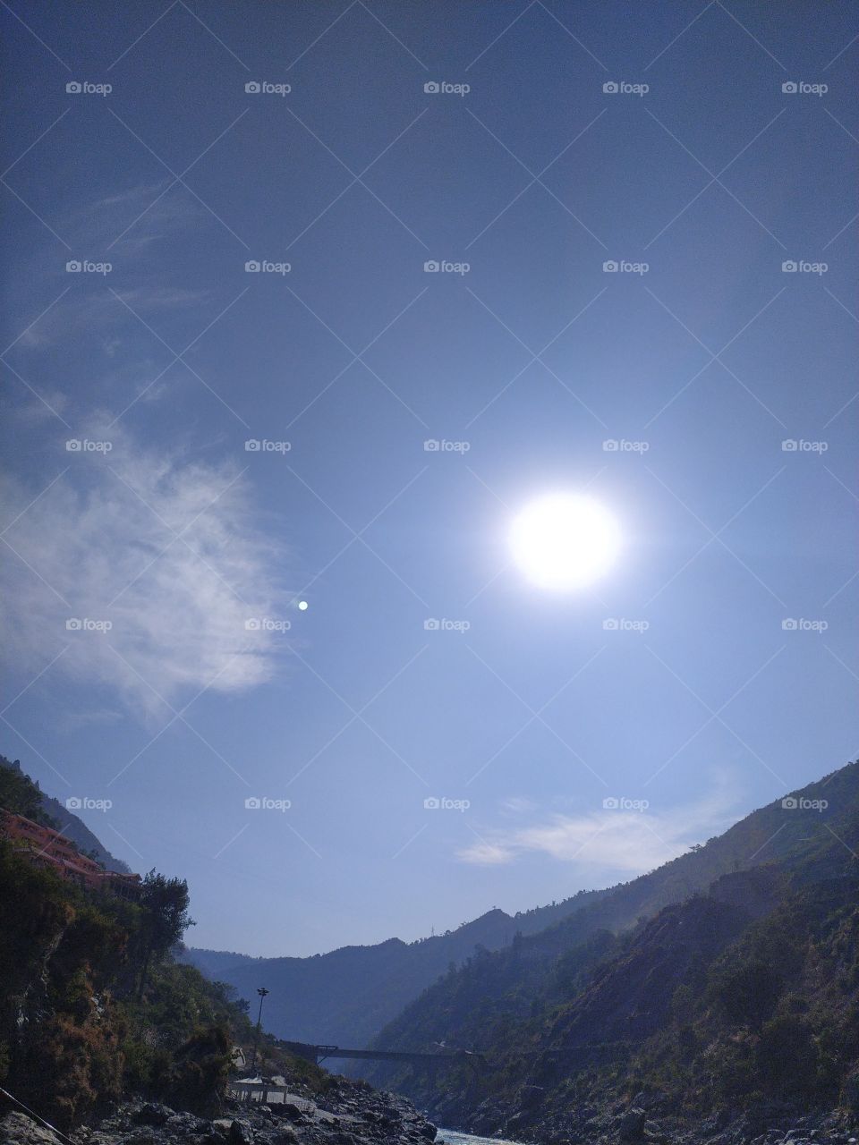 hills, mountains and the winter sun with patches of stray clouds