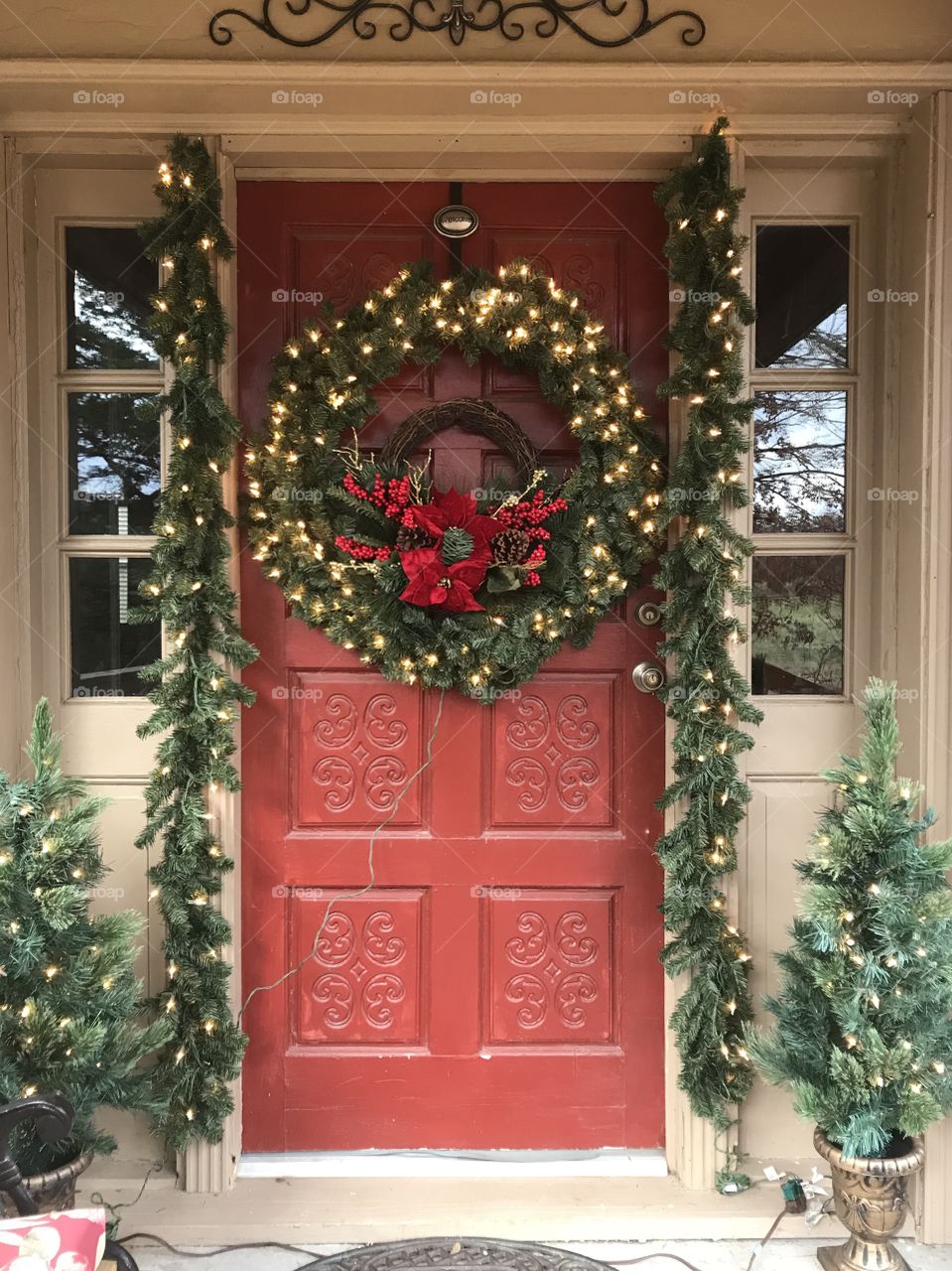The joy of Christmas! Front entry door decked out in greenery and lights is sure to give a warm welcome to all who enter.