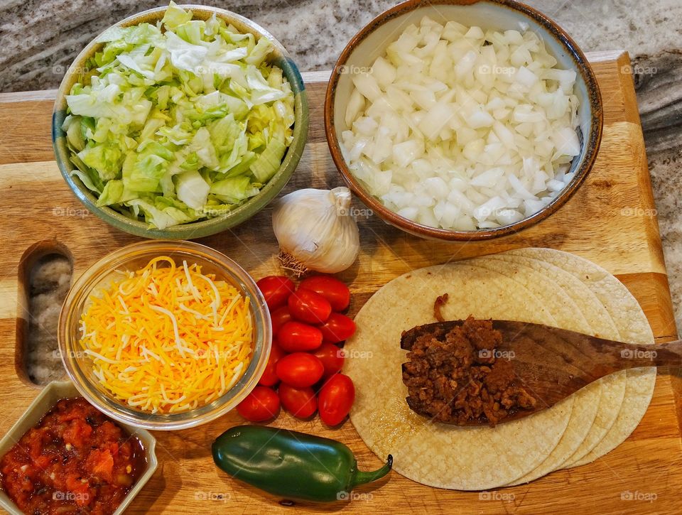 Tacos with chopped vegetables in bowl