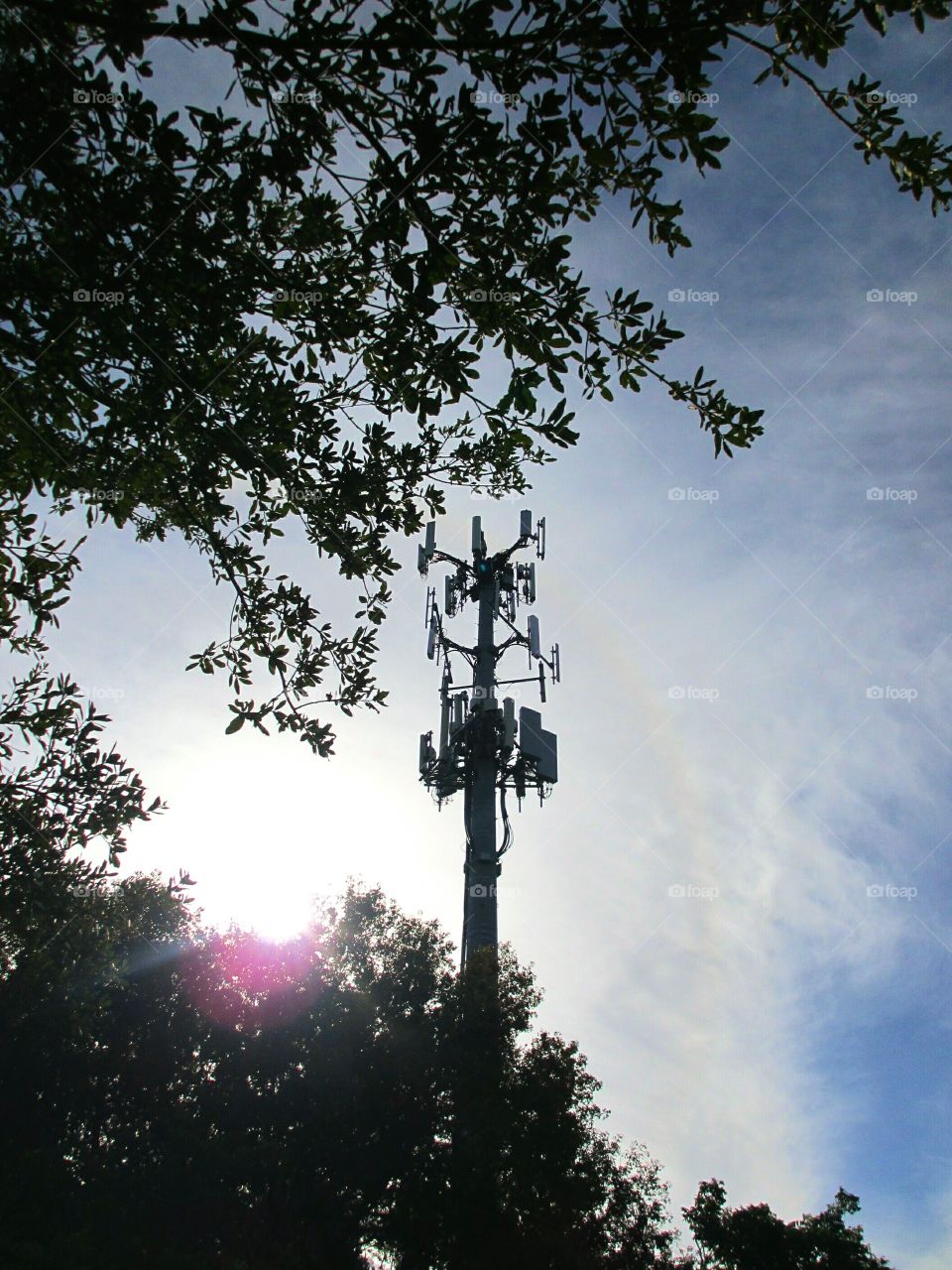Communication Tower. A microwave / commincation tower, the sun and a hint of a rainbow
