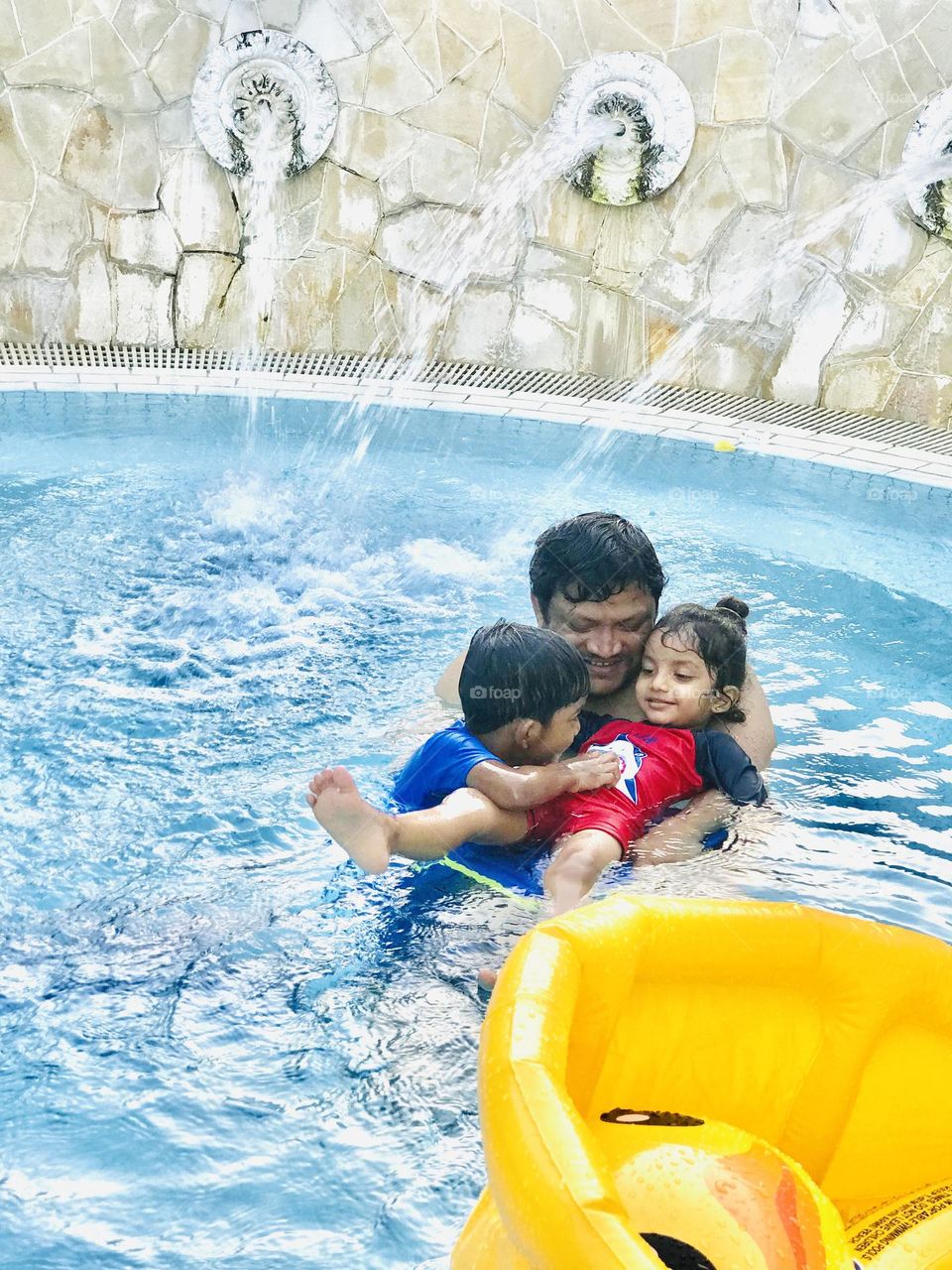 Enjoying at swimming pool together with family 