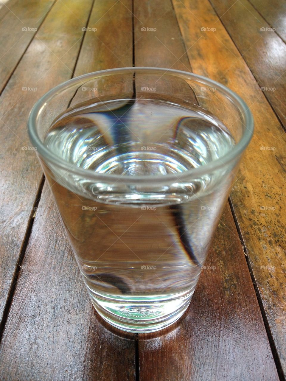 A glass of water on wood table