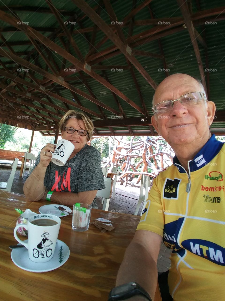 usaving coffee before a ride at a Mountain Bike Track. It makes us happy to cycle together because: we love to cycle, it takes our minds off  normal routine, we love being outdoors enjoying the clean air and nature, it keeps us young, healthy and fit
