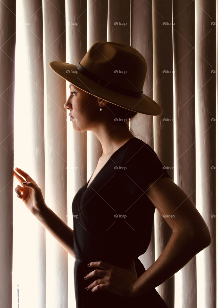 Woman looking out the window for the one she loves