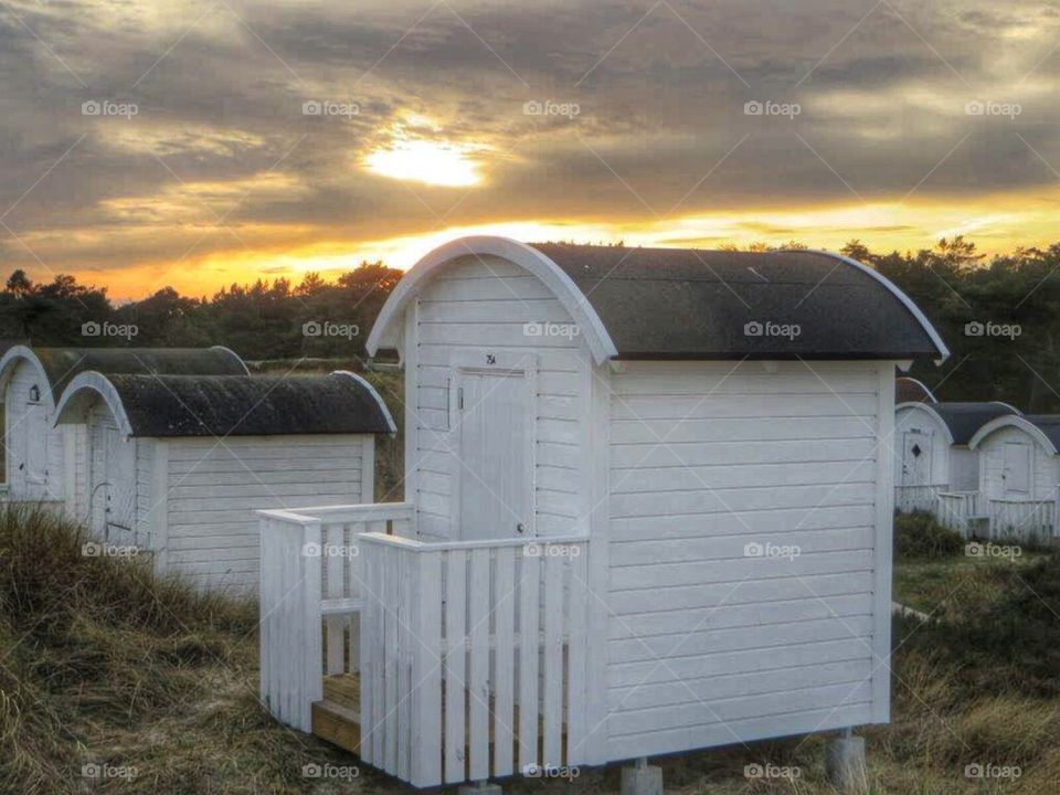 Beach huts in sunset 