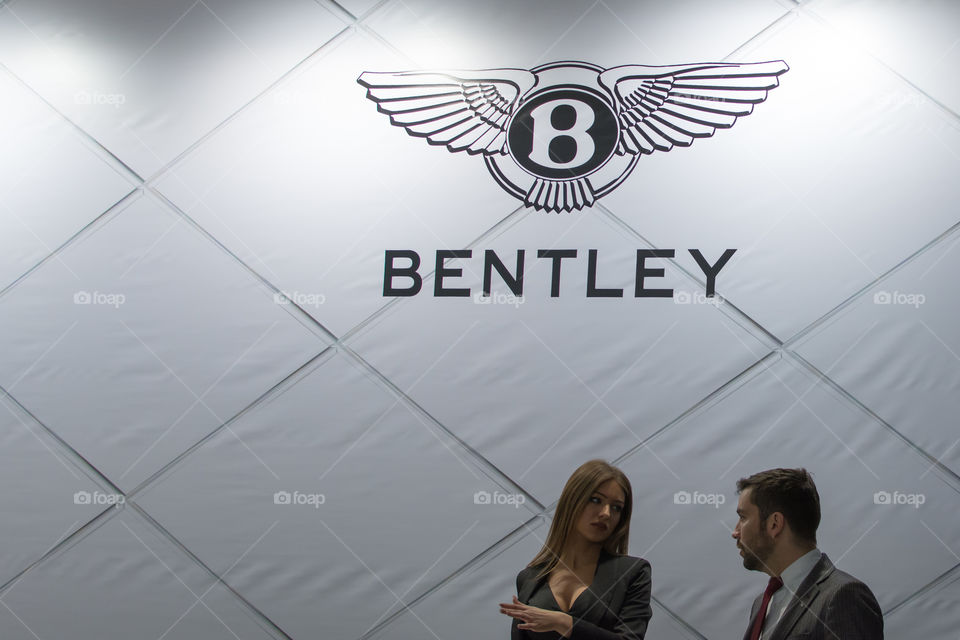 bentley luxury logo with salesman on the picture, beautiful woman, luxury car manufacturer, aristocracy, modern, powerful, england, great britain