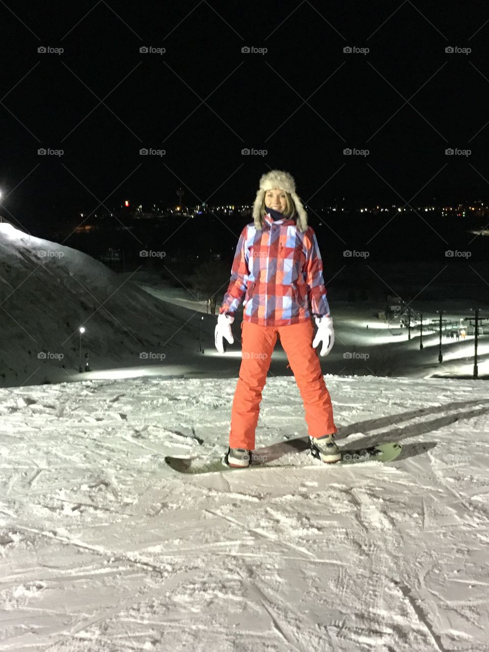 Happy woman rides snowboard