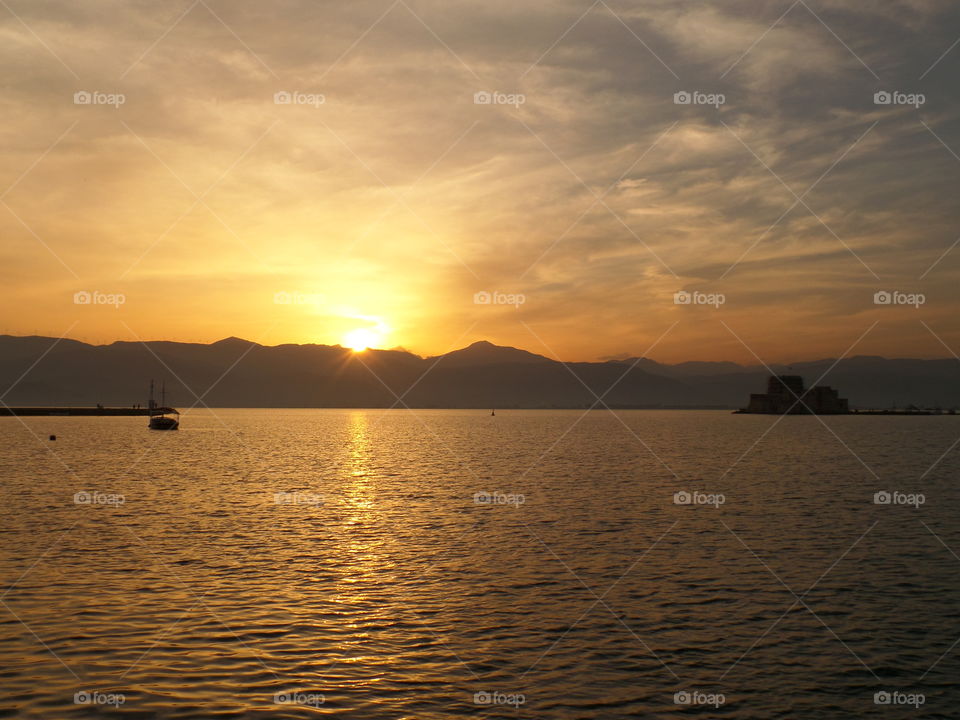 Beautiful Golden Sky during the Sunset over Aegean Sea, Nafplio, Greece