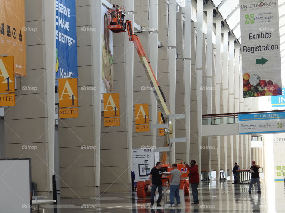 Men Working Hard. Men, working with a boom lift. 