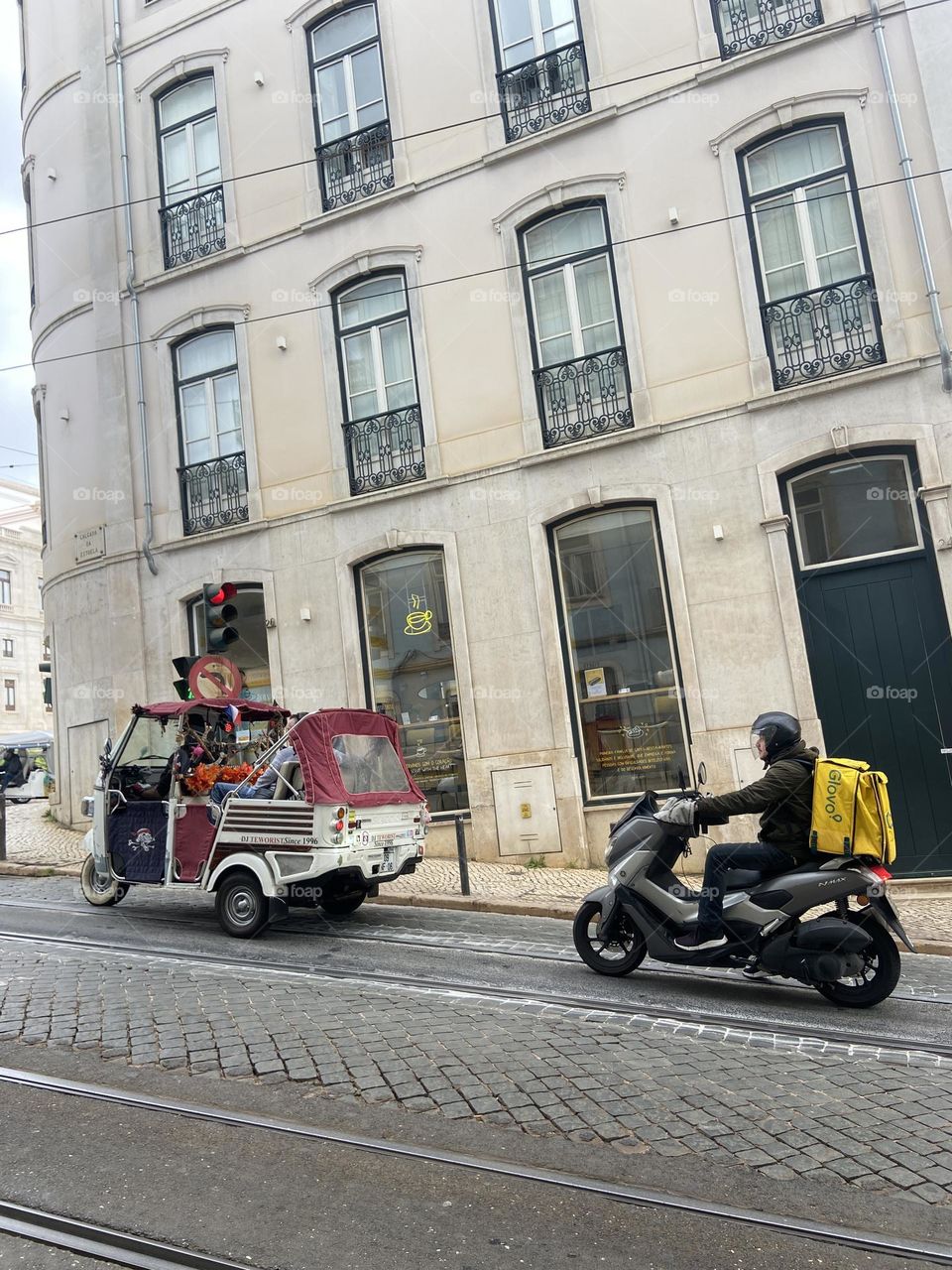 Street in lisbon with tuk tuk and moto