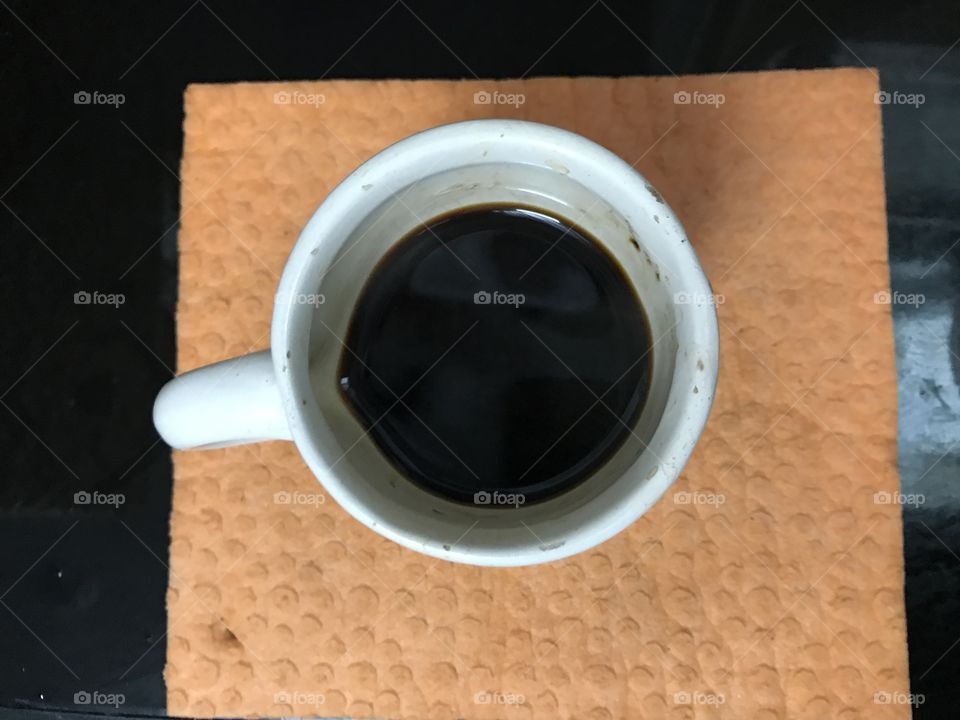 Top view of a cup of coffee on wood table 