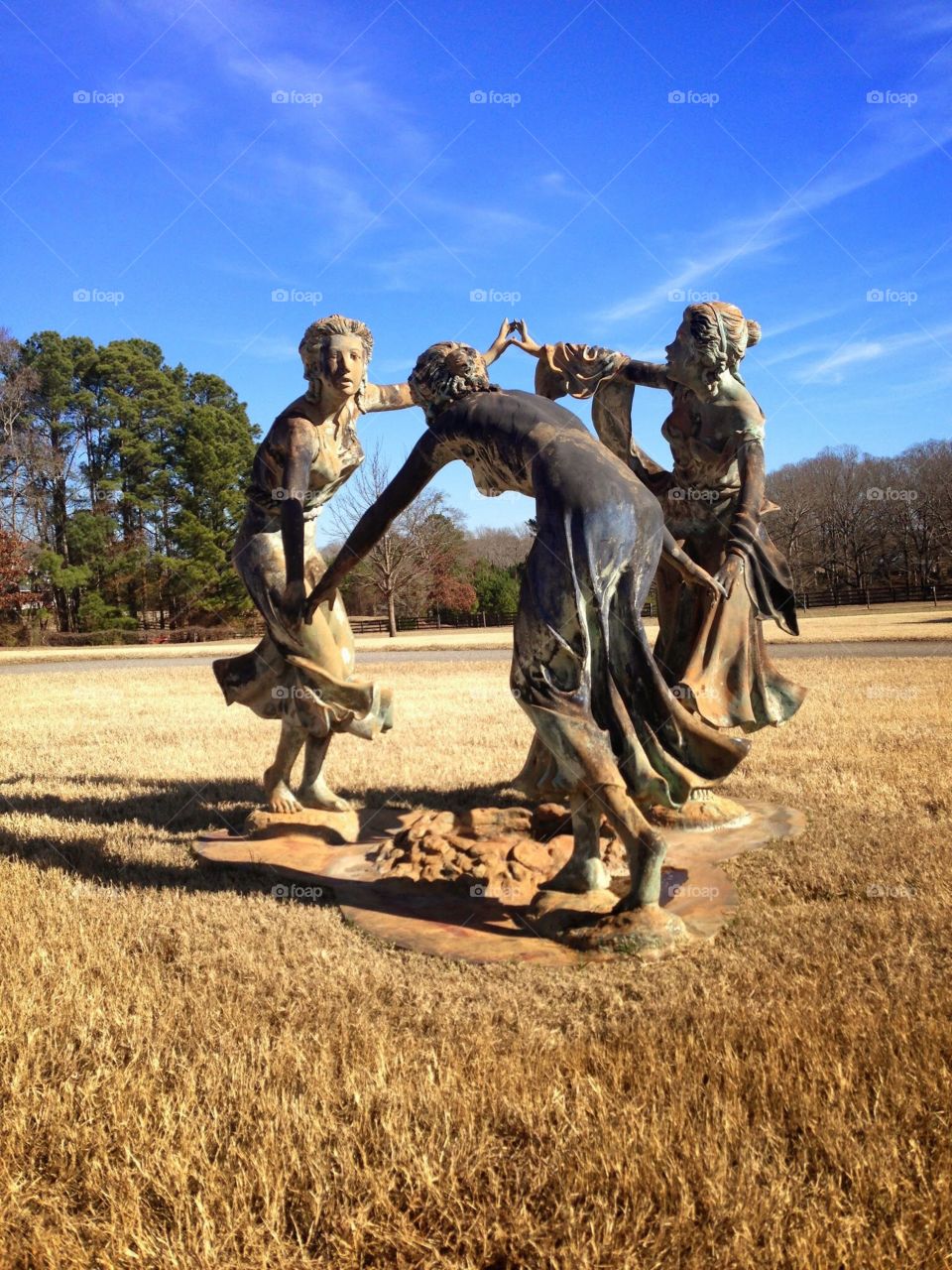 Statues of 3 girls playing Ring Around the Rosie