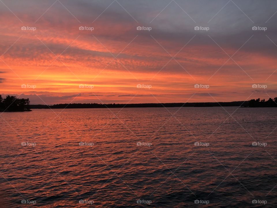 beautiful red orange summer sunset over a large river
