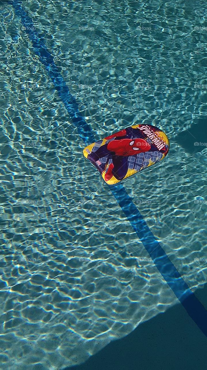 Spiderman floatie. Early morning at the poolside
