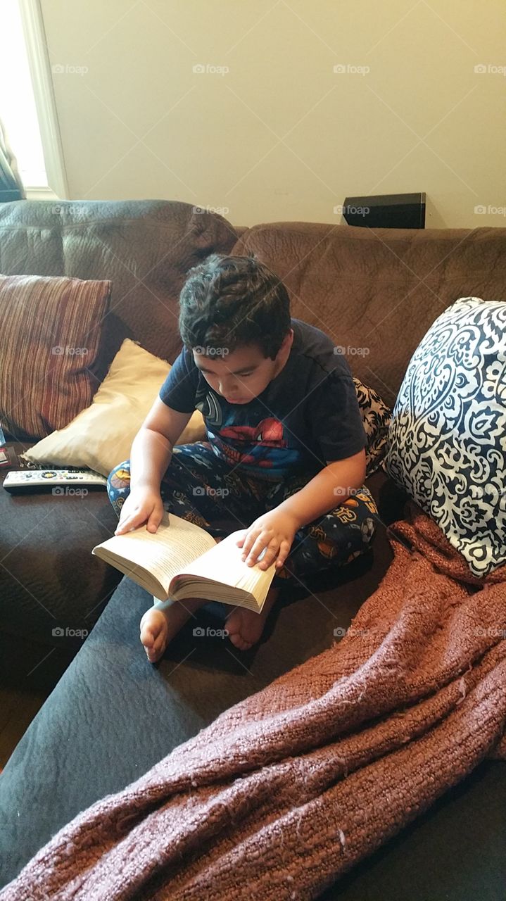 a boy reading a book
