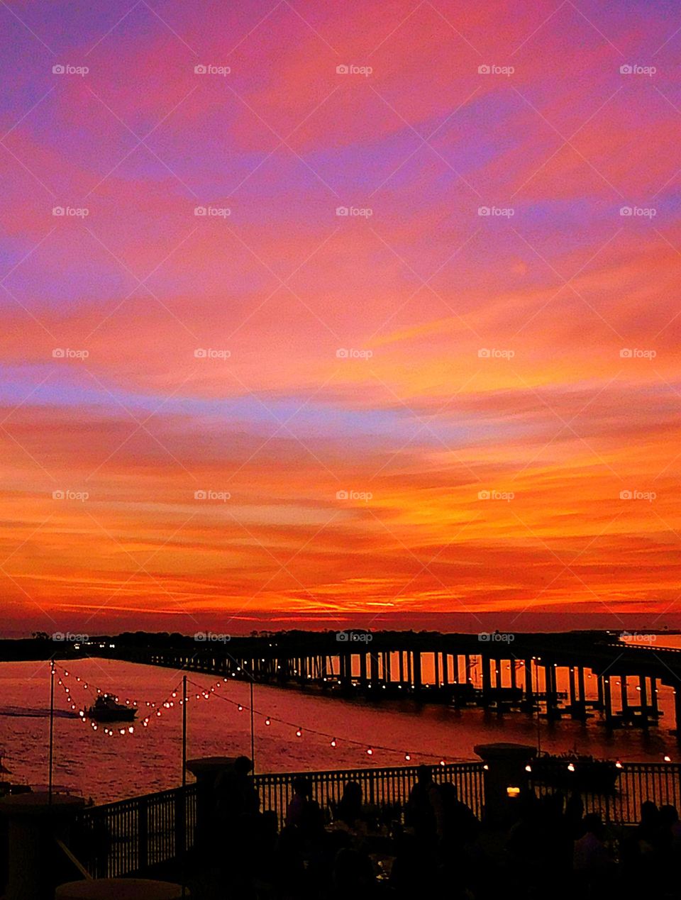 A multi colored sky captures the eyes just after sunset over a bridge in the Gulf of Mexico