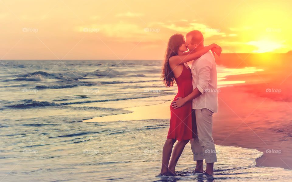 Romantic Couple at the Beach at Sunset.