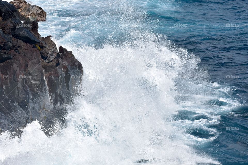 Big waves and splashes on the sea cliffs on the eastern side of the island