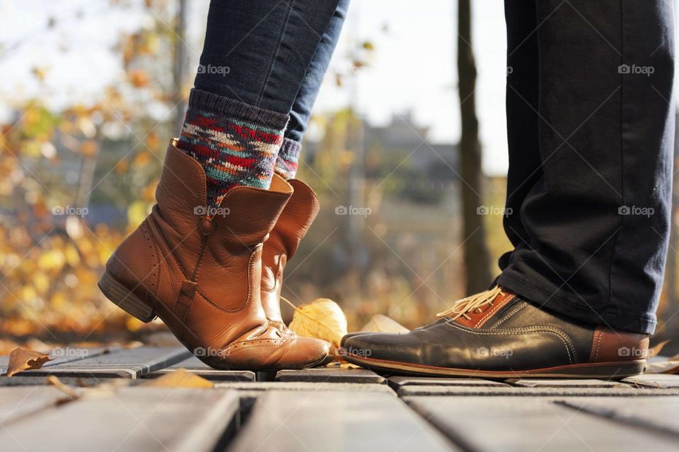 Close up of legs couple in kissing outdoor in autumn