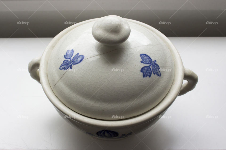 Old white and blue porcelain bowl with crackled lid 