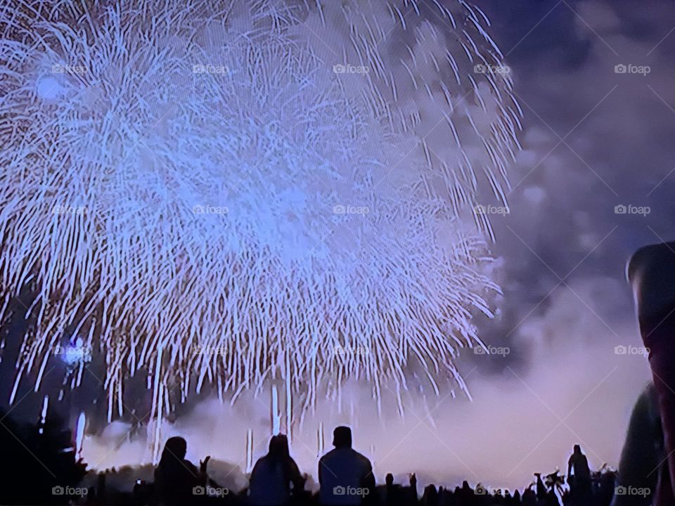 Crowds enjoying fireworks.