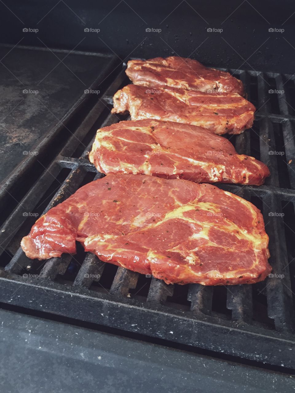 Barbercue - grilling meet. Just put up on the grill so its still raw